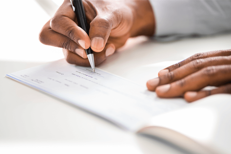 hands writing in a notebook
